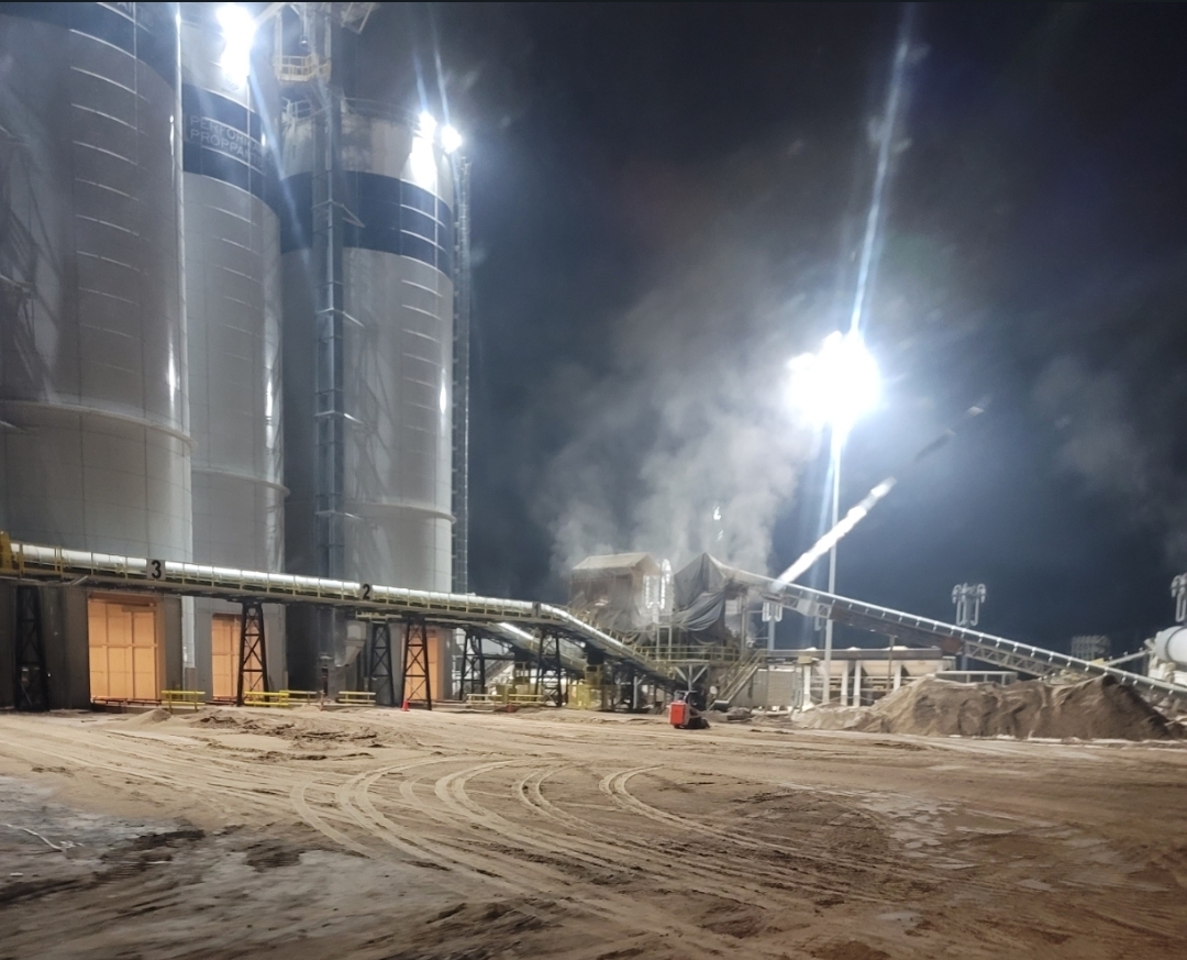 Frac sand silos at night - StarBrand Transport loading facility